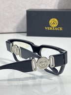 Versace eyeglasses with dark blue frames, clear lenses, and silver medallion temple bars