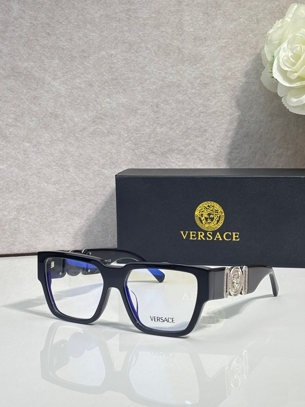 Versace eyeglasses with dark blue frames and clear lenses with metallic temple emblem