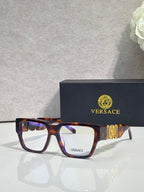 Versace eyeglasses with tortoise frames, clear lenses, and metallic temple emblem