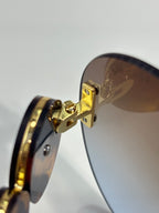 Versace pilot sunglasses close-up, gold-tone hinge and temple connection