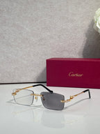 Cartier eyeglasses with gold-tone temples, clear lenses, dark top frame