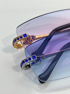 Cartier eyeglasses close-up of temple in gold with blue crystal inlays.