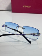 Cartier eyeglasses with light blue lenses, navy temples, and blue rhinestone link details.