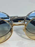 Cartier round eyeglasses side view with mixed metal frame and reflective tinted lenses