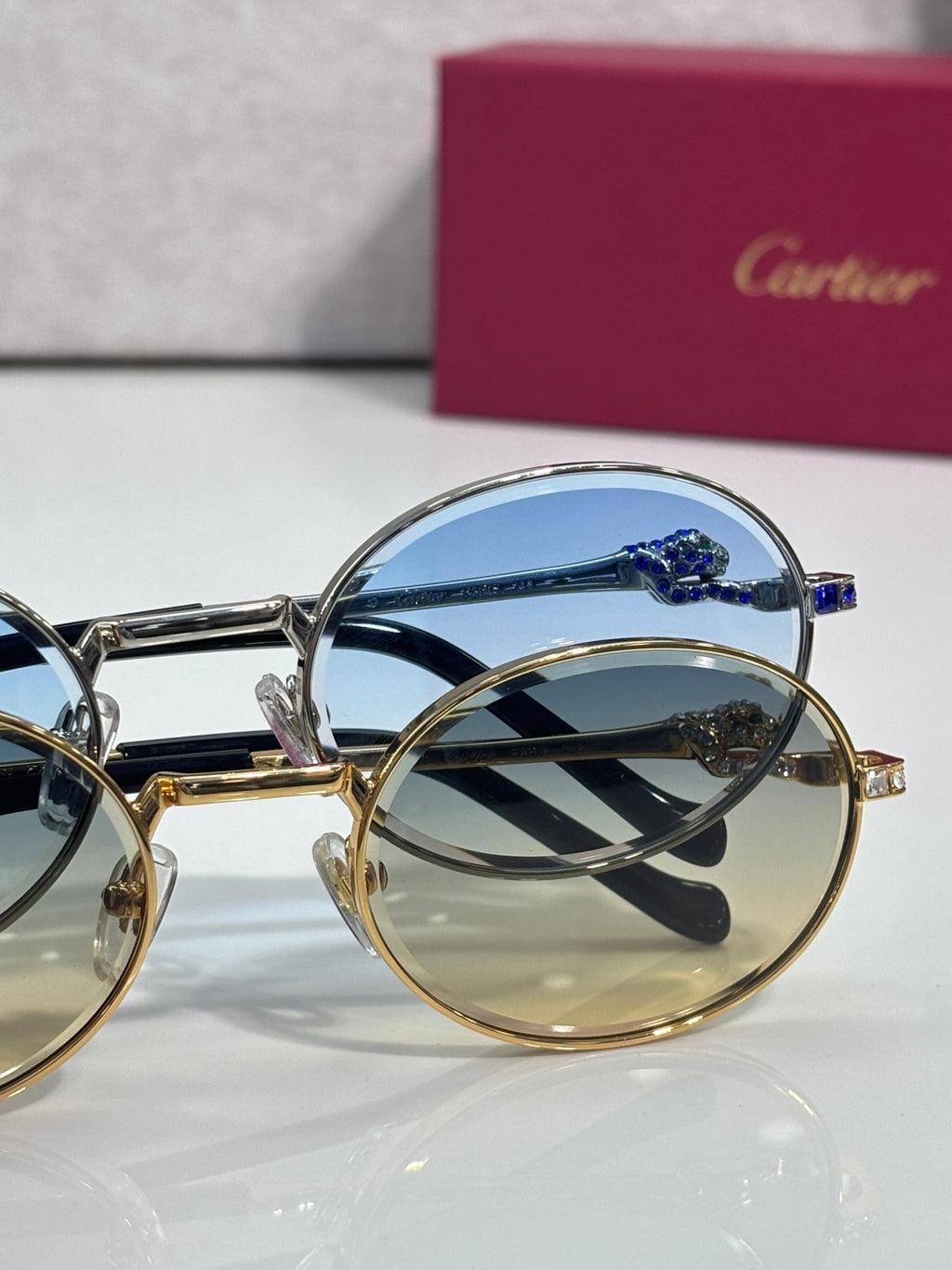 Cartier round eyeglasses close-up: blue tinted lenses with gold and silver frames