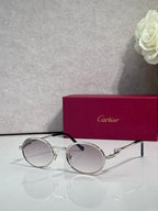 Cartier round eyeglasses with silver frame, clear lenses, black temple tips