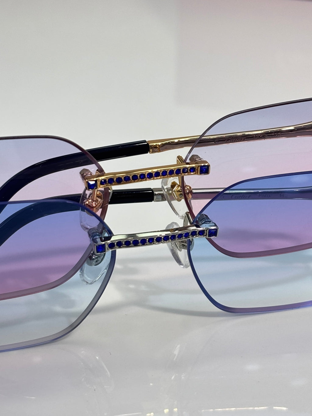 Blue crystal inlaid gold eyeglasses with clear-to-purple gradient lenses