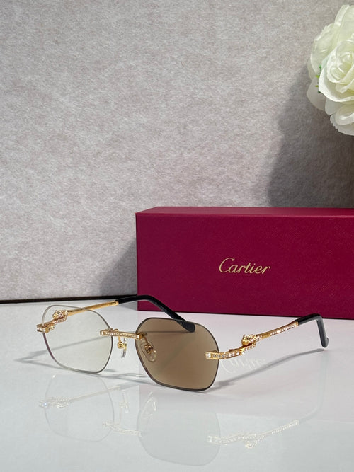 Gold metal eyeglasses with amber-tinted lenses and black temples, jeweled arms