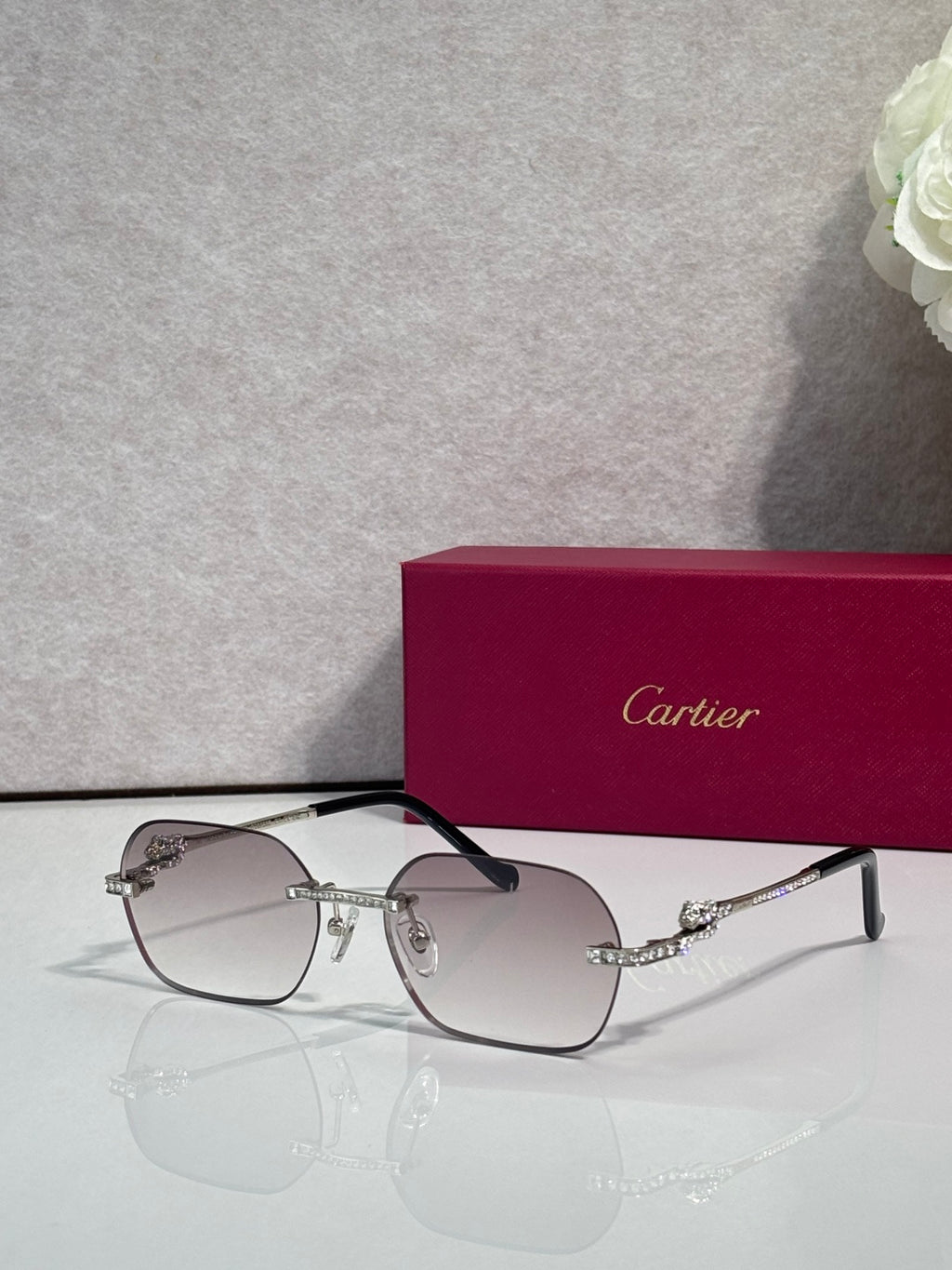 Cartier eyeglasses with black-and-gold frame, gradient lenses and decorative side detailing