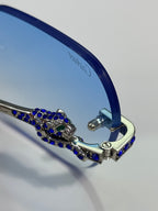 Cartier eyeglasses close-up: blue temple with ornate rhinestone bar and gold hinge