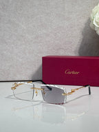 Gold metal eyeglasses with rectangular clear lenses and ornate bridge detail