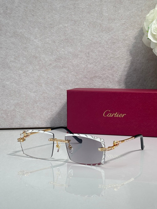 Gold metal eyeglasses with rectangular clear lenses and ornate bridge detail