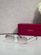 Silver metal eyeglasses with rectangular clear lenses and decorative temple accents
