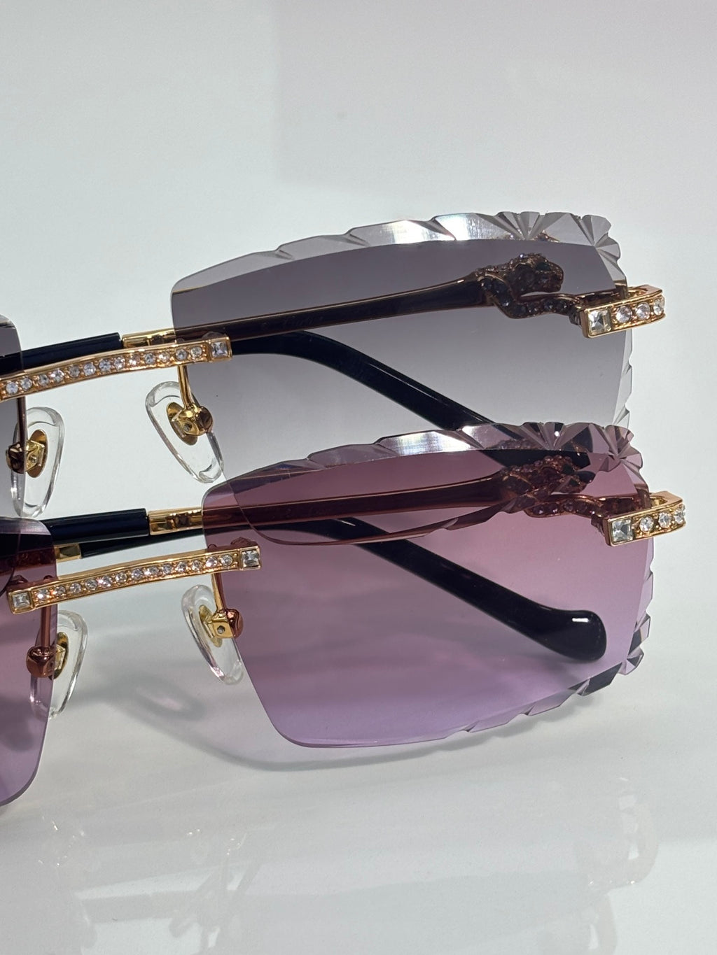 Cartier rectangular sunglasses close-up: jewel bar on rim with purple-tinted lens