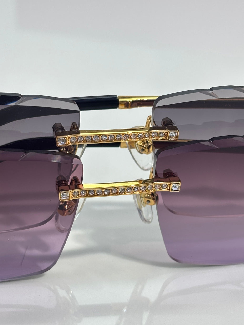 Cartier rectangular sunglasses close-up: gold-tone hinges with crystal strip on temple