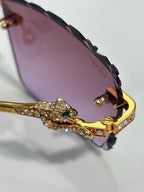Cartier gold-tone sunglasses detail: jeweled bridge and hinge with purple gradient lens