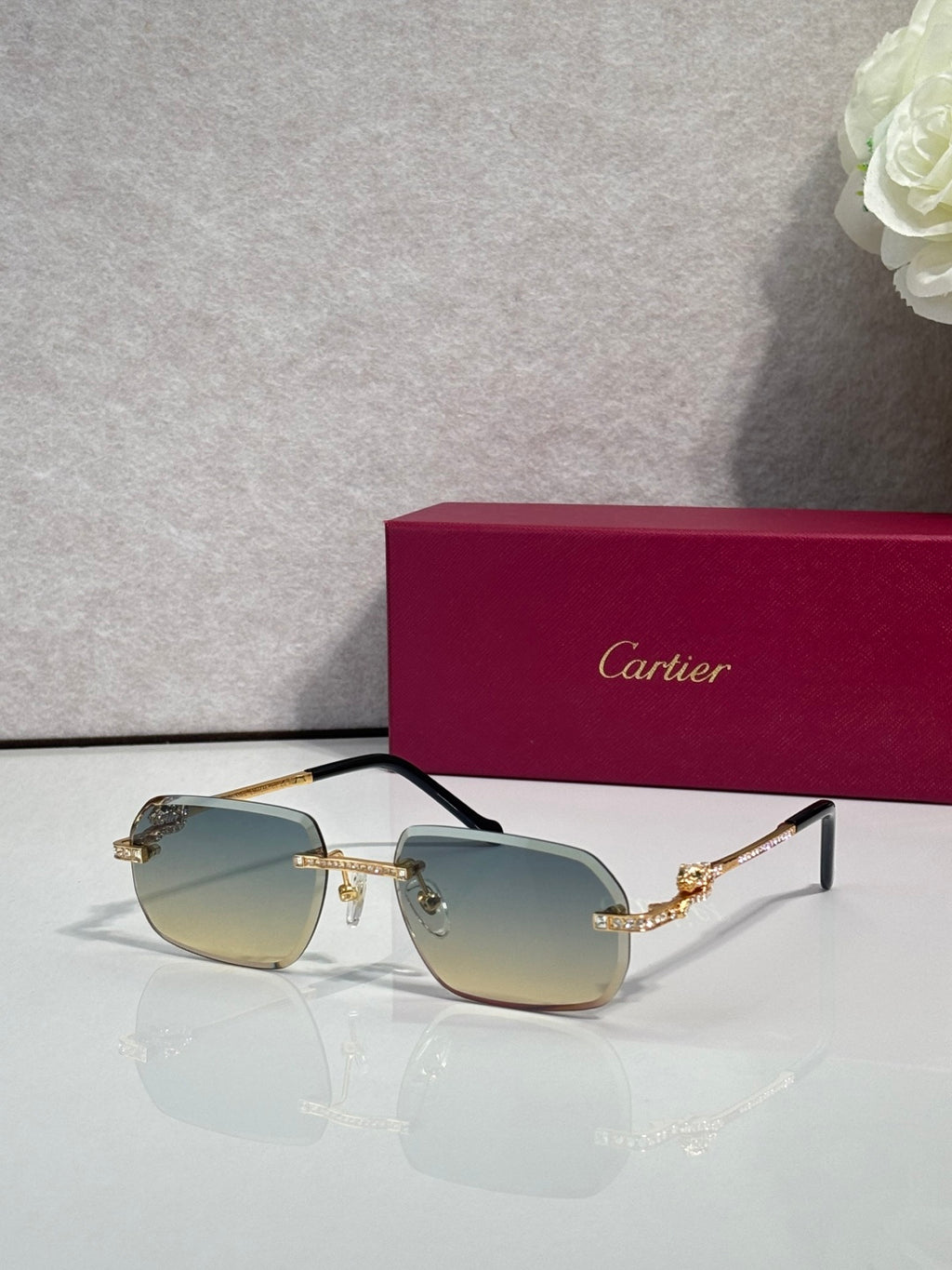 Gold-tone eyeglasses with green-tinted lenses and ornate temple motifs