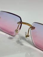 Pink gradient eyeglass frame with clear nose pads and gold-toned metal bridge