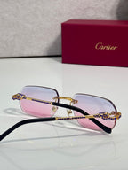 Cartier eyeglasses with black temples and pink lenses, blue gem crown detail