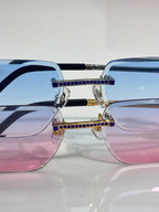 Cartier eyeglasses with blue lenses, gold frame and blue jewel bar