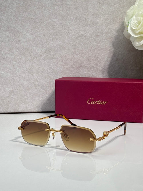 Cartier eyeglasses with gold frame and amber lenses, blue gem accents