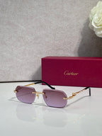 Cartier eyeglasses with gold frame and mauve lenses, blue gem accents