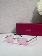 Cartier eyeglasses with gold frame and pale pink lenses, blue gem accents