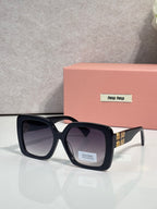 MiuMiu square sunglasses with dark lenses, black frame, gold logo details