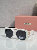 MiuMiu square sunglasses with dark lenses, white frame, gold logo on temple