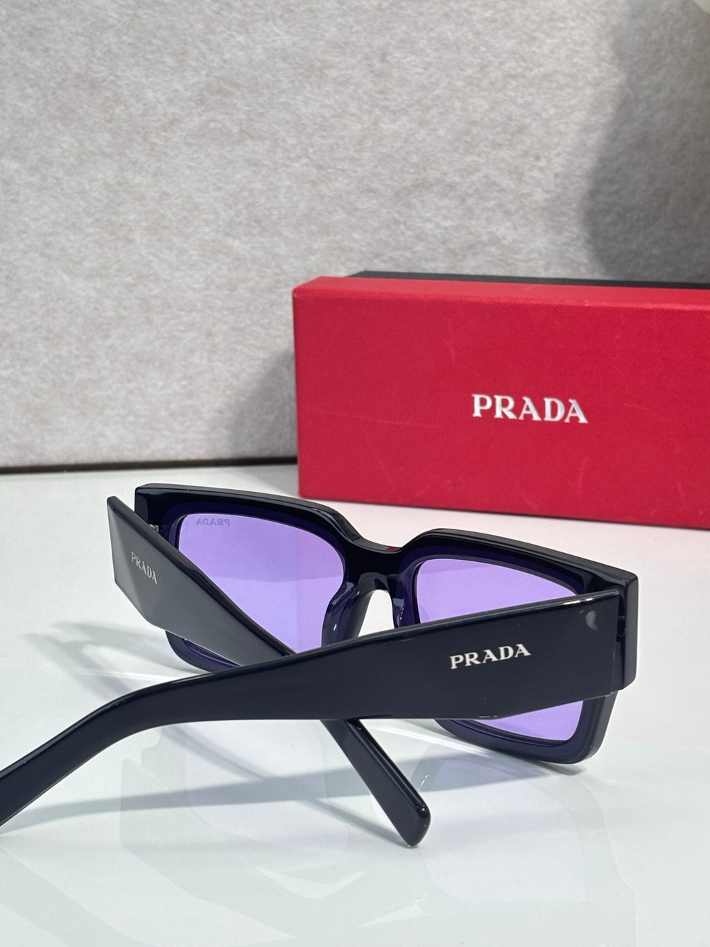 Black sunglasses with purple lenses and Prada logo on temple
