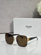 Celine sunglasses with dark frames, gold accents, and brown tinted lenses.