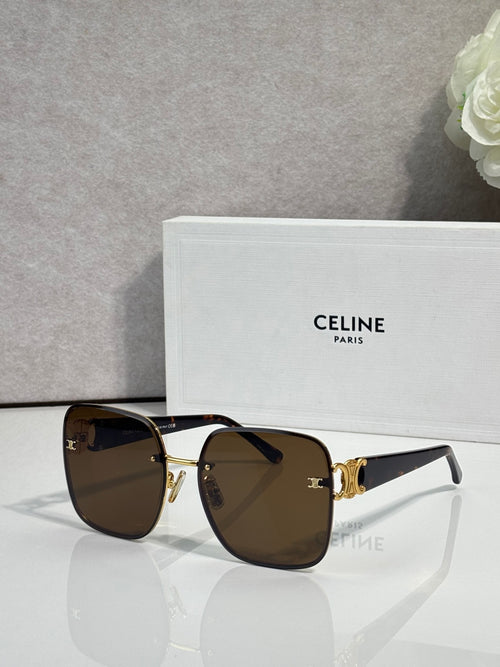 Celine sunglasses with dark frames, gold accents, and brown tinted lenses.