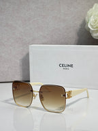 Celine sunglasses with light brown frames, gold accents, and amber tinted lenses.