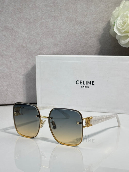 Celine sunglasses with dark frames, gold accents, and blue tinted lenses.