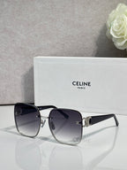 Celine sunglasses with black frames, gold accents, and dark tinted lenses.