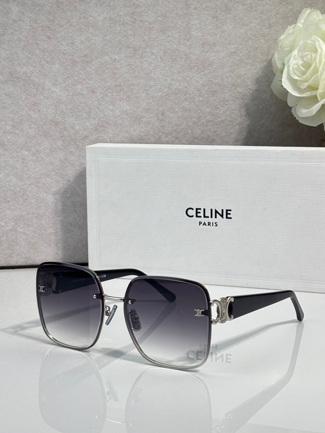 Celine sunglasses with black frames, gold accents, and dark tinted lenses.