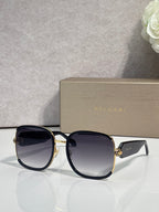 Round sunglasses with black frame, gold rim, dark tinted lenses
