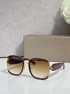 Round sunglasses with burgundy frame, gold accents, gradient tinted lenses