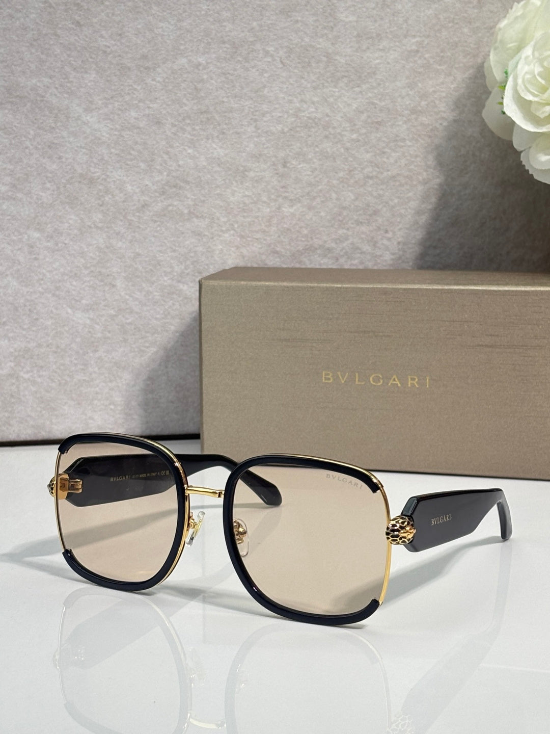Oversized round sunglasses with dark frame, gold rim, dark tinted lenses