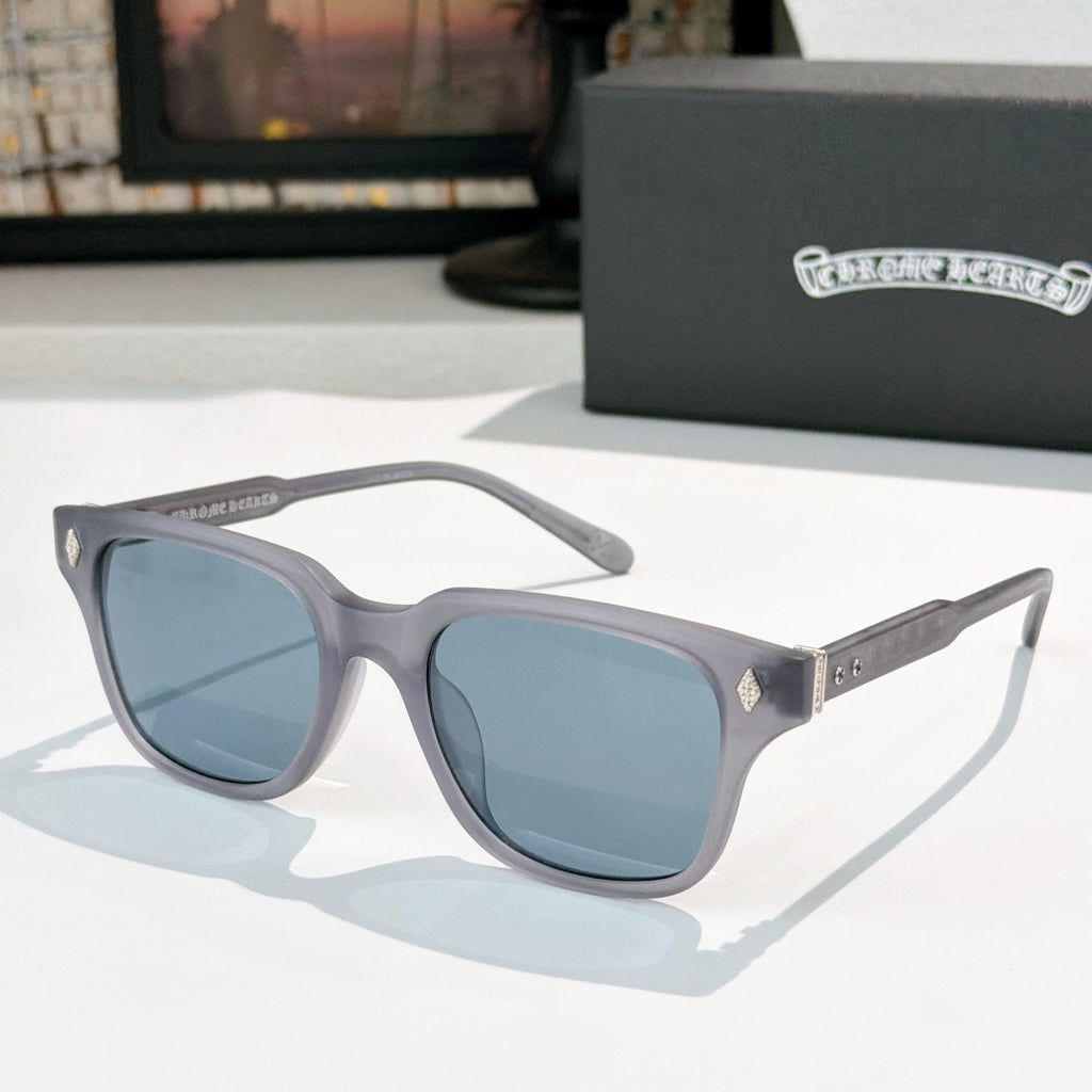 Gray square sunglasses with blue-tinted lenses and silver patterned temple accents