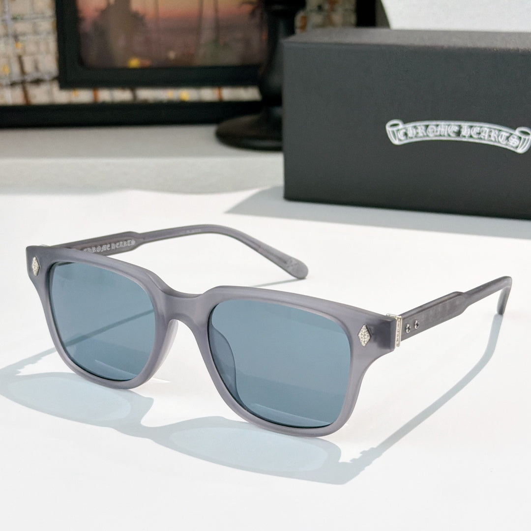 Gray square sunglasses with blue-tinted lenses and silver patterned temple accents