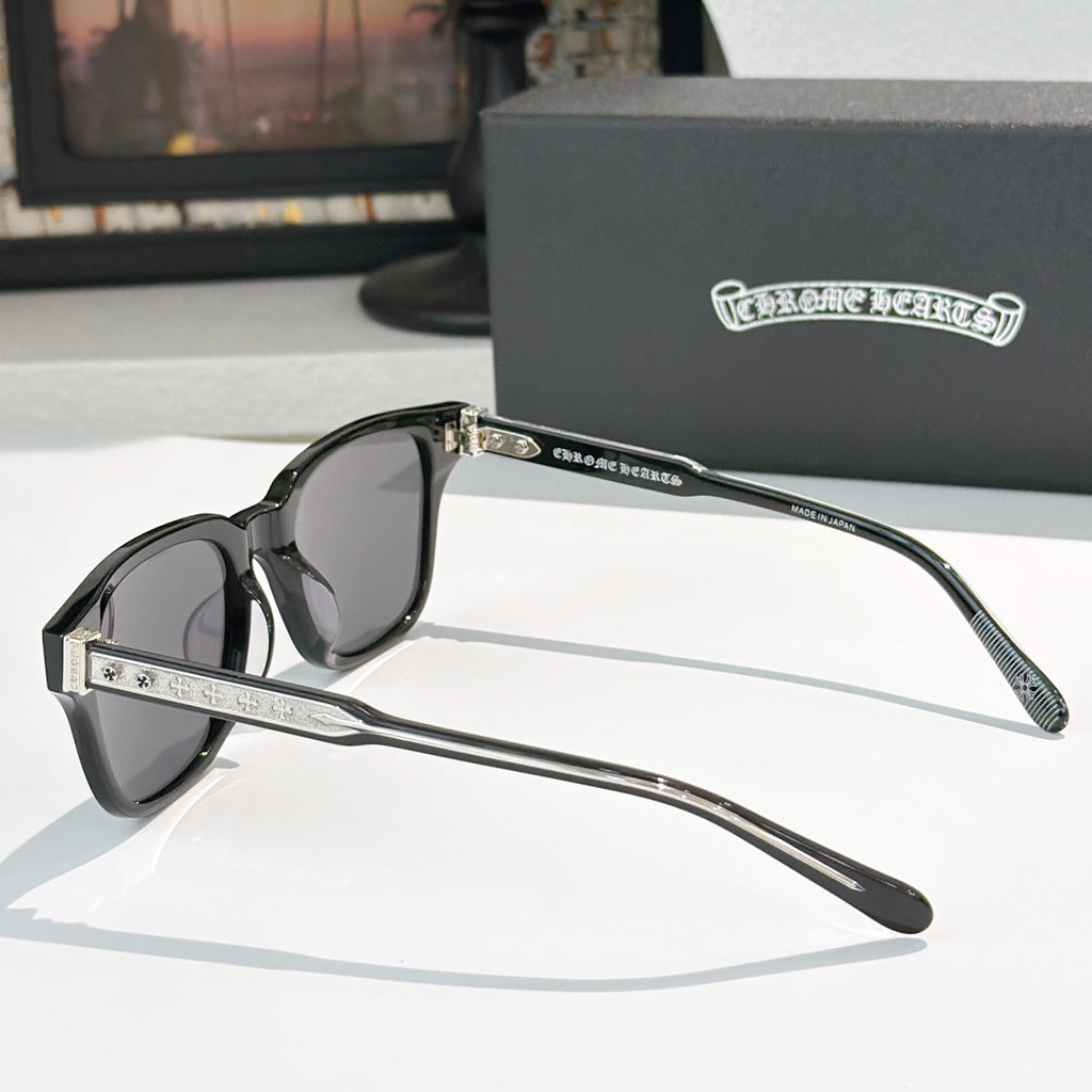 Black square sunglasses with dark tinted lenses and silver patterned temple details
