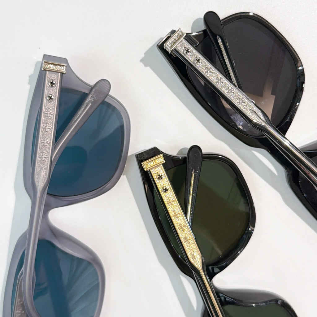 Assorted sunglasses in blue, green, and black with patterned gold-tone temple bars