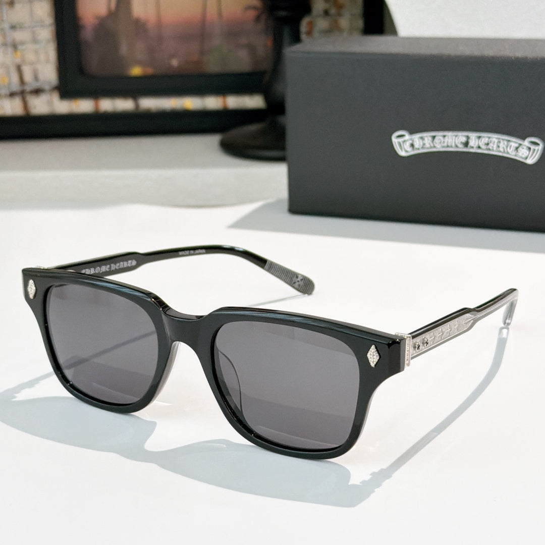 Black square sunglasses with dark tinted lenses and silver patterned temple inlay
