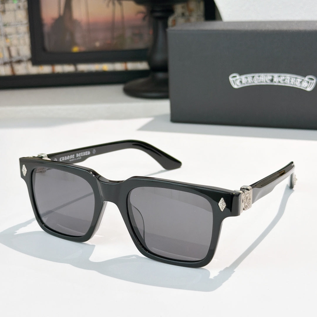 Black square sunglasses with dark lenses and silver-tone accents