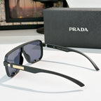 Prada black rectangular sunglasses, side view with tinted lenses and gold logo hinge