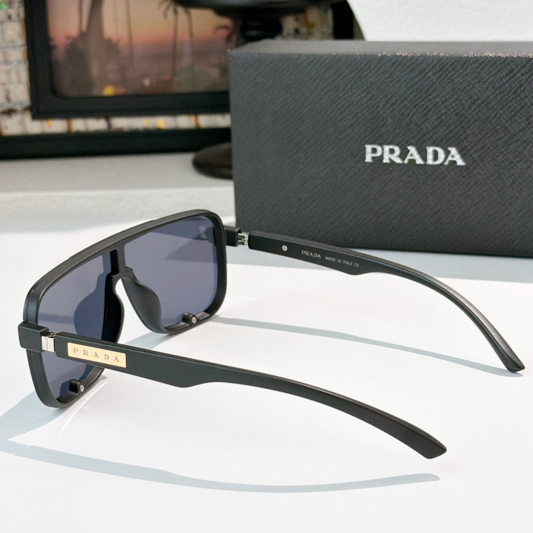 Prada black rectangular sunglasses, side view with tinted lenses and gold logo hinge