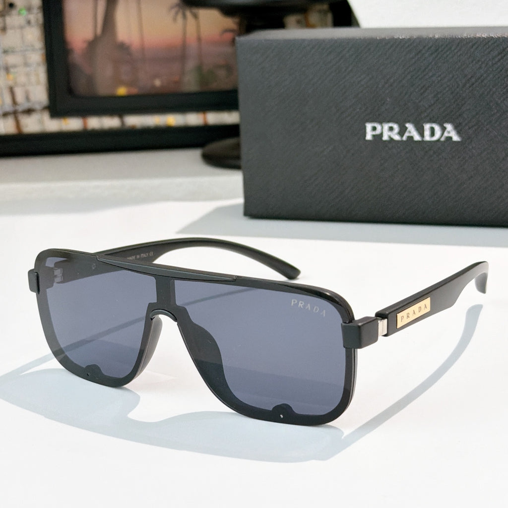 Prada black rectangular sunglasses with light blue gradient lenses and gold logo temple