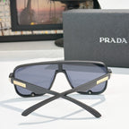 Prada black rectangular sunglasses, front view with tinted lenses and gold logo hinge
