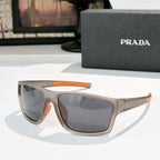 Prada sunglasses with beige frame, orange accent arms, dark tinted lenses